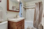 Guest Bathroom offers newly tiled tub/shower